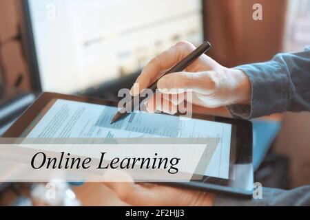 The tablet in the hands of a businessman. The inscription is the Online Learning Stock Photo