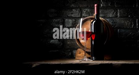 Red wine on a background of old black bricks Stock Photo