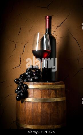 Wine on barrel in cellar with clay wall Stock Photo