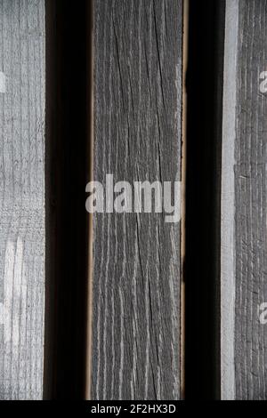 Faded, parallel wooden slats against a black background Stock Photo