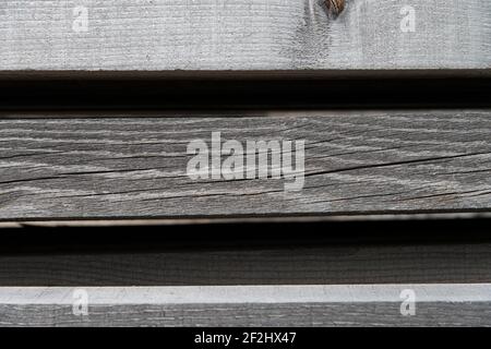 Faded, parallel wooden slats against a black background Stock Photo