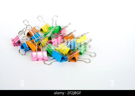 Multi color paper binder clips on white background Stock Photo