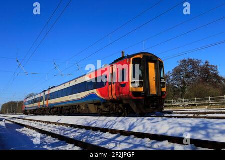 Winter snow, 158788 EMR, East Midlands Regional Trains, East Coast Main Line Railway, Peterborough, Cambridgeshire, England, UK Stock Photo