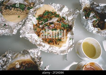 Street Style Tacos with Assorted salsas in tinfoil Stock Photo