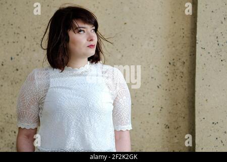 Beautiful young parisian woman with green eyes and dressed in white Stock Photo