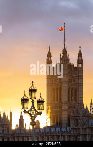 Beautiful sunset over the Palace of Westminster with lamp post in foreground, as seen from Westminster Bridge, London, December 2020