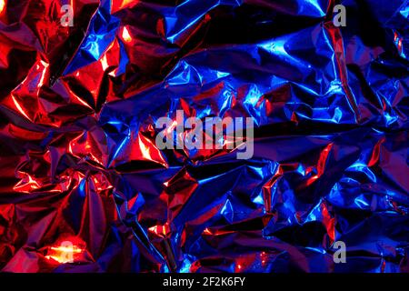 Abstract red and blue aluminum wrinkled foil background texture reflecting  red and blue light Stock Photo - Alamy