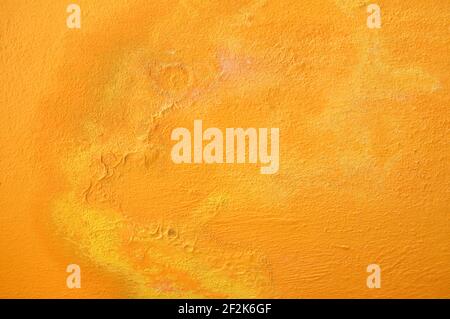 Textured Background of Yellow Cracking Paint on a Concrete Wall Horizontal Stock Photo