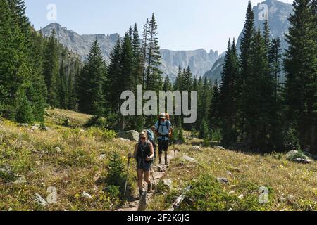 Couple hiking on mountain during vacation Stock Photo