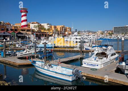 Lighthouse and pleasure boats moored in marina of the port of seaside resort Cabo San Lucas on the peninsula of Baja California Sur, Mexico Stock Photo