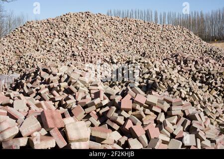 Pile of red and grey old construction bricks Stock Photo