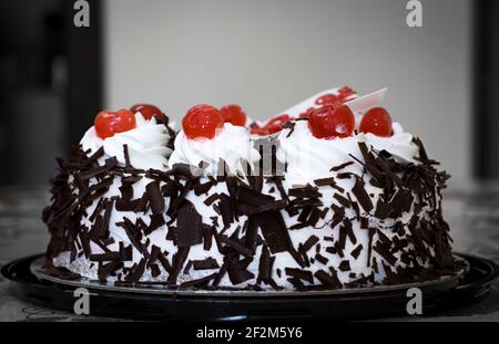 Sweet Black Forest Round Cake With Red Cherry On The Top Stock Photo