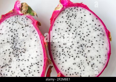 Pitahaya Dragon Fruit pulp. Closeup of fruit pitaya half cutted on a white plate. Stock Photo