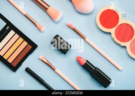 Different makeup female cosmetics and accessories on a blue background.Make Up Beauty Fashion Concept Stock Photo