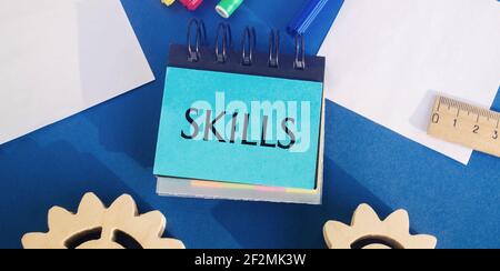 Notes with the word Skills on a blue background. Knowledge and skill. Self improvement. Education concept. Training. Leadership skills. Human abilitie Stock Photo
