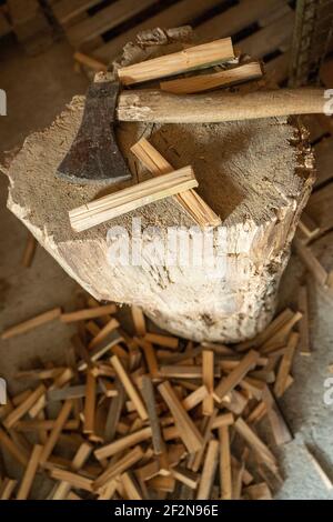 Chopping block with ax and split wood. Stock Photo