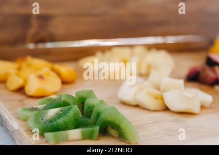 Chopped Fresh Fruits Arranged On Cutting Board On White Wooden Background  With Copy Space, Top View. Ingredients For Fruit Salad. From Above, Flat  Lay, Overhead. Stock Photo, Picture and Royalty Free Image.