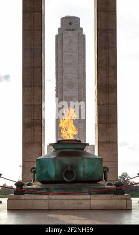 Eternal flame in the Triumphal Propylaea of the Homeland and main tower. National Flag Memorial located at Rosario city, Argentina. Stock Photo