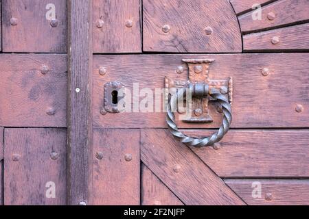 Germany, Rhineland-Palatinate, Gleiszellen-Horbach, old wooden gate with door knocker. Stock Photo