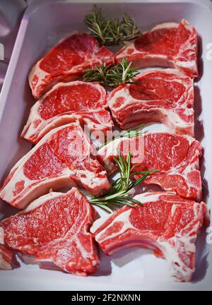 Raw lamb chops on a tray in an Italian butcher shop Stock Photo