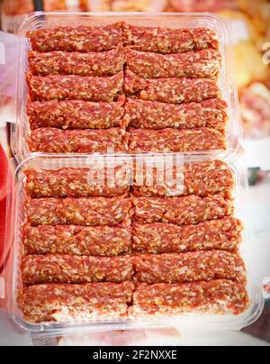 Romanian uncooked meat rolls called mititei, mici - close-up. Romanian traditional food Stock Photo