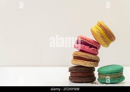 French crash macarons. Stack of macaron with dorblu and wine isolated on white background. Colorful macaroons. Top view. Stock Photo