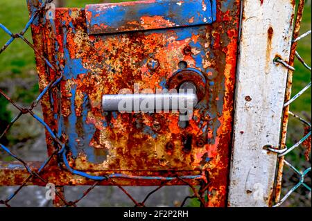 Old door handle on a rusted gate Stock Photo
