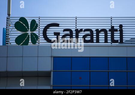 Bucharest, Romania - January 21, 2021: A logo of Garanti BBVA, Turkish multinational banking and financial services group, is displayed above a buildi Stock Photo