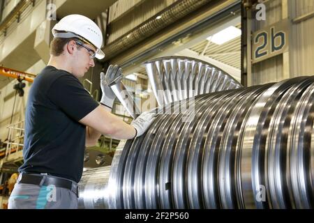 Topic photo, job cuts at Siemens Energy - young engineer in production, cooperative engineering training at Siemens Energy, the cooperative engineering training is a dual degree, a skilled worker training ("apprenticeship") is combined with a degree in engineering, Mülheim on der Ruhr, North Rhine-Westphalia, Germany, archive picture from 07/15/2013 Stock Photo