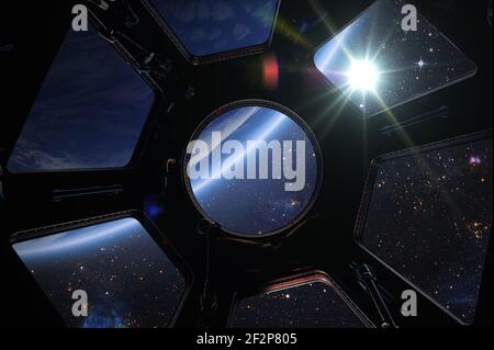 Earth, Sun and galaxy from spaceship international space station window. Elements of this image furnished by NASA Stock Photo