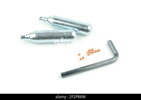 Co2 Cartridges, Pellets and Hex Key for Air Gun Isolated on White Background. Stock Photo