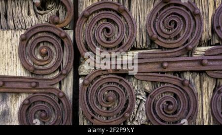 Iron fittings on the door of the Marcevol priory church. Was built in the XII century. Monument historique. Stock Photo