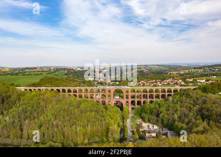 Largest brick arch bridge in the world (574 m long, 78 m high) Train, houses, valley, forest Stock Photo