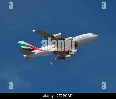 London, Heathrow Airport - March 2020: Emirates Airways, Airbus A380, climbing and gaining altitude through a clear, bright blue sky. image Abdul Qura Stock Photo