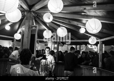 Germany, Bavaria, Antdorf, festival week of the traditional costume association. Bar of the marquee with lanterns. Stock Photo