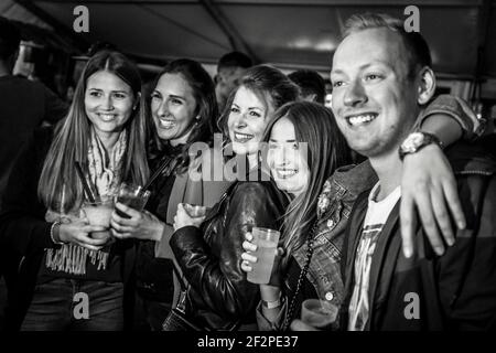 Germany, Bavaria, Antdorf, festival week of the traditional costume association. Young participants of the party pose for a photo in the marquee. Stock Photo