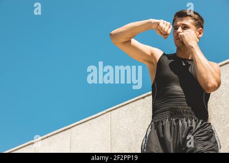 Man exercising and fighting in outside, boxer in gloves. male boxer portrait Stock Photo