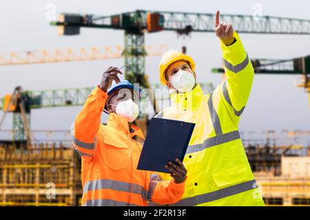 Construction Site Engineer And Building Inspection Pointing Stock Photo