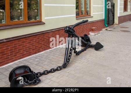 Old anchor and chains on the embankment of the city of Rybinsk Stock Photo