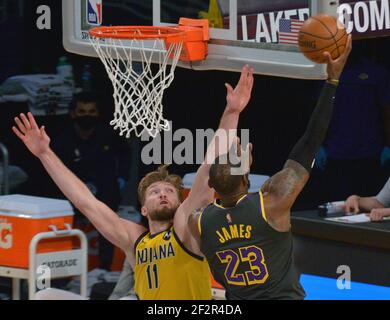 Los Angeles, United States. 12th Mar, 2021. Los Angeles Lakers' forward LeBron James scores on Indiana Pacers' power forward Domantas Sabonis during the fourth quarter at Staples Center in Los Angeles on Friday, March 12, 2021. The Lakers defeated the Pacers 105-100. Photo by Jim Ruymen/UPI Credit: UPI/Alamy Live News Stock Photo