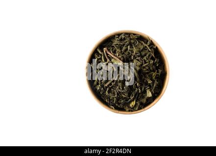 Green tea in reusable round cardboard packaging isolated on white background. View from above.  Stock Photo
