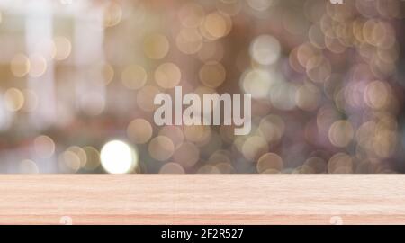 Wooden shelf over blur bokeh light background. Empty wood table top, counter for display product for promotion. Stock Photo