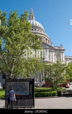 LONDON, UK - MAY 24, 2010:  Tourist reading information map at St Paul's Cathedral Stock Photo