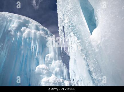 Frozen mountain waterfall with icicles against blue sky Stock Photo