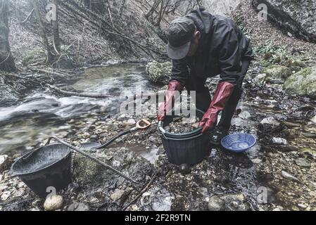 Outdoor adventures on river. Gold panning, search for gold Stock Photo