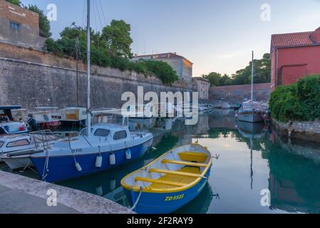 Sunrise view of a marina situated next to the land gate in Croatian town Zadar Stock Photo