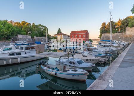 Sunrise view of a marina situated next to the land gate in Croatian town Zadar Stock Photo