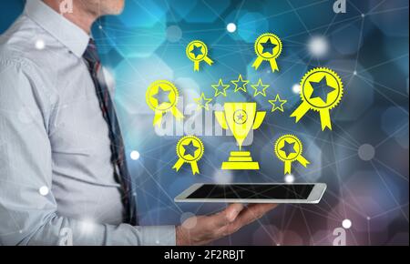 Quality concept above a tablet held by a man Stock Photo