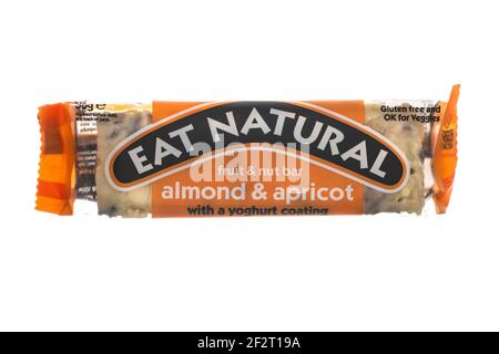 SWINDON, UK - MARCH 13, 2021: Eat Natural protein packed cruncy fruit and nut bar with almond and apricot and a yoghurt coating on a white background. Stock Photo