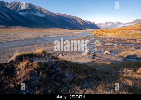 Owl River bed in arctic remote valley, Akshayuk Pass, Nunavut. Beautiful arctic landscape in the late, sunny afternoon. Iconic mountains on distant Stock Photo